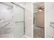 Modern bathroom featuring a glass shower with marble tiling and a view into the bedroom at 1022 Mariners Ct, Stone Mountain, GA 30083