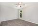 Bedroom with a ceiling fan and plush carpet at 1022 Mariners Ct, Stone Mountain, GA 30083