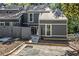 Charming exterior view of a two-story home with gray siding, fenced yard, and paved parking at 1022 Mariners Ct, Stone Mountain, GA 30083