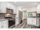 Well-lit kitchen with stainless steel appliances, granite countertops, and dark gray tile backsplash at 1022 Mariners Ct, Stone Mountain, GA 30083