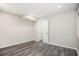 An empty room with LVP flooring, fresh paint and a view to another room at 1022 Mariners Ct, Stone Mountain, GA 30083