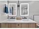 Bright bathroom features double sinks, a marble countertop, light wood cabinets, and modern fixtures at 201 W Ponce De Leon Ave # 402, Decatur, GA 30030