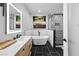 Modern bathroom features a stylish tub, patterned shower, contemporary fixtures, and illuminated mirror at 201 W Ponce De Leon Ave # 402, Decatur, GA 30030