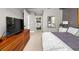 This bedroom features modern decor, and a TV atop a wooden cabinet, offering a comfortable and stylish retreat at 201 W Ponce De Leon Ave # 402, Decatur, GA 30030