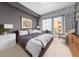 The primary bedroom features neutral colors, a private balcony, and a sleek design for relaxing and unwinding in style at 201 W Ponce De Leon Ave # 402, Decatur, GA 30030