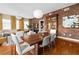 A spacious dining room showcases wood floors, a brick wall, modern lighting, and an open layout connected to the living areas at 201 W Ponce De Leon Ave # 402, Decatur, GA 30030