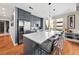 The modern kitchen features gray cabinetry, stainless steel appliances, a large center island, and sleek quartz countertops at 201 W Ponce De Leon Ave # 402, Decatur, GA 30030