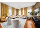 A spacious living room has hardwood floors, a decorative chandelier, and a cozy seating arrangement with an exposed brick wall at 201 W Ponce De Leon Ave # 402, Decatur, GA 30030