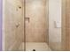 Walk-in shower with beige tiling, a built-in niche, and a glass door for a spa-like experience at 201 W Ponce De Leon Ave # 402, Decatur, GA 30030