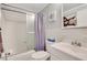 Well-lit bathroom with a shower-tub combo, white tile, and modern fixtures at 300 Peachtree Ne St # 22N, Atlanta, GA 30308
