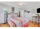 Comfortable bedroom with a decorative ceiling fan, artwork and a writing desk space at 300 Peachtree Ne St # 22N, Atlanta, GA 30308