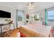 Bright bedroom featuring a ceiling fan, large windows with great views, and a cozy desk area at 300 Peachtree Ne St # 22N, Atlanta, GA 30308
