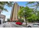 Exterior street view of a high-rise building with mature trees at 300 Peachtree Ne St # 22N, Atlanta, GA 30308