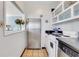 Compact kitchen with stainless steel refrigerator, white cabinets, and tile flooring at 300 Peachtree Ne St # 22N, Atlanta, GA 30308