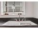 Close-up of a kitchen sink with modern fixtures and a bright window at 300 Peachtree Ne St # 22N, Atlanta, GA 30308