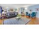 Spacious living room with black leather couch, wood floors, and blue accent pillows at 300 Peachtree Ne St # 22N, Atlanta, GA 30308