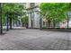 View of a pedestrian street featuring unique architecture, landscaping, and shade trees at 300 Peachtree Ne St # 22N, Atlanta, GA 30308