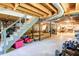 Unfinished basement with exposed beams, concrete floor, and ample storage space at 4265 Hurt Bridge Rd, Cumming, GA 30028