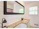 Updated bathroom with a granite countertop, framed mirror, shiplap accent wall, and tiled floors at 4265 Hurt Bridge Rd, Cumming, GA 30028