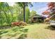 Charming home surrounded by lush greenery and a spacious front yard at 4265 Hurt Bridge Rd, Cumming, GA 30028
