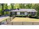 Charming ranch-style home with a well-manicured lawn and mature trees, offering a peaceful and inviting curb appeal at 4265 Hurt Bridge Rd, Cumming, GA 30028