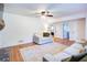 Relaxing living room featuring a ceiling fan, hardwood floors, and access to other rooms for seamless living at 4265 Hurt Bridge Rd, Cumming, GA 30028
