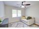 Bright room with a ceiling fan, couch, rug, and natural light through the window at 4265 Hurt Bridge Rd, Cumming, GA 30028