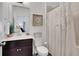 Bathroom featuring modern fixtures, dark wood vanity and shower with floral shower curtain at 758 Cady Way, Atlanta, GA 30312