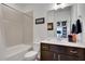 Well-lit bathroom featuring a shower-tub combination and a vanity with dark wood cabinets at 758 Cady Way, Atlanta, GA 30312