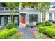 Charming entryway features a vibrant red door, cozy seating, and beautiful landscaping at 758 Cady Way, Atlanta, GA 30312