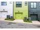 Close-up exterior shot of multi-colored townhomes with garages and air conditioning units at 758 Cady Way, Atlanta, GA 30312