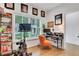 Bright home gym featuring a Peloton bike, desk, shelves, and natural light from a large window at 758 Cady Way, Atlanta, GA 30312