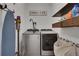 Clean laundry room featuring modern front-load washer and dryer with shelving at 758 Cady Way, Atlanta, GA 30312