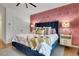 Stylish main bedroom featuring a plush blue bed, patterned wallpaper, and ample natural light at 758 Cady Way, Atlanta, GA 30312