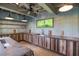 Outdoor kitchen area featuring rustic wood cabinetry, a sink, and modern lighting at 758 Cady Way, Atlanta, GA 30312