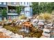 Close up of waterfall feature surrounded by rocks and lush landscaping at 758 Cady Way, Atlanta, GA 30312