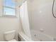 Bright bathroom featuring a soaking tub with a shower and tiled walls at 77 Glenn Se St, Atlanta, GA 30312