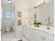 Bright bathroom with double vanity, white cabinets, and tiled shower at 77 Glenn Se St, Atlanta, GA 30312