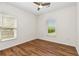 Bright bedroom featuring wood floors, ceiling fan, and large windows at 77 Glenn Se St, Atlanta, GA 30312