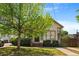 Charming home featuring a lush green lawn, mature tree, and inviting front porch at 77 Glenn Se St, Atlanta, GA 30312