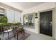 Charming front porch features seating and a view of the front door and manicured landscape at 77 Glenn Se St, Atlanta, GA 30312