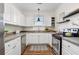 Well-lit kitchen boasts white cabinets, stainless appliances, and granite countertops at 77 Glenn Se St, Atlanta, GA 30312