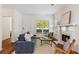 Comfortable living room with fireplace, hardwood floors, and plenty of natural light at 77 Glenn Se St, Atlanta, GA 30312
