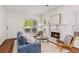 Bright living room featuring a fireplace, hardwood floors, and cozy seating area at 77 Glenn Se St, Atlanta, GA 30312