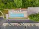 Aerial view of a community pool, lounge area, and colorful townhomes surrounded by lush greenery at 1356 Peter Haughton Nw Way, Atlanta, GA 30318