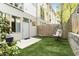 Cozy backyard featuring synthetic grass, a hanging chair, and a wooden fence at 1356 Peter Haughton Nw Way, Atlanta, GA 30318