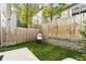 Outdoor space with synthetic grass, stone retaining wall, and hanging chair at 1356 Peter Haughton Nw Way, Atlanta, GA 30318