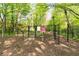 Fenced dog park with mulched ground and play area, providing a safe and fun space for pets at 1356 Peter Haughton Nw Way, Atlanta, GA 30318