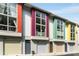 Modern townhome exterior with colorful accents and individual garage doors at 1356 Peter Haughton Nw Way, Atlanta, GA 30318
