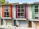 Modern townhome exterior with colorful accents and individual garage doors at 1356 Peter Haughton Nw Way, Atlanta, GA 30318